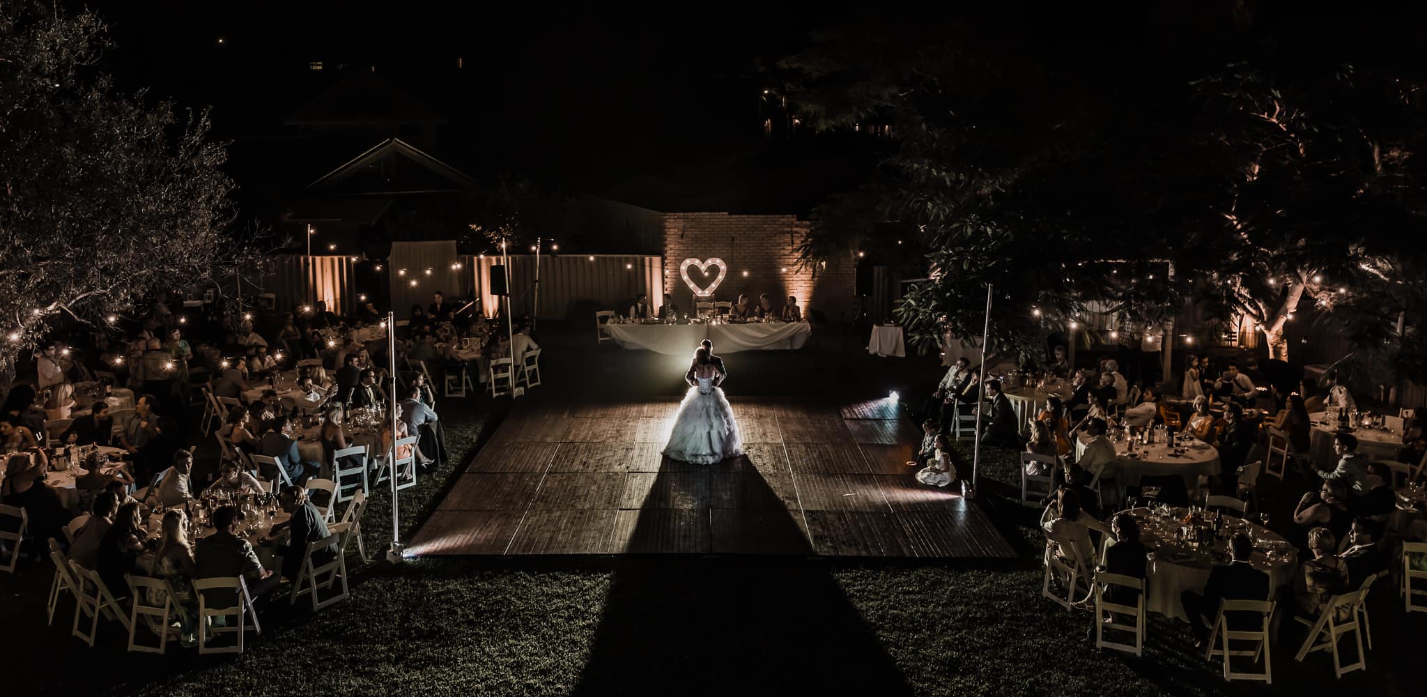 Perth Award Winning Documentary Wedding Photographer Adam Levi Browne photographs an aerial photograph of a bride and groom dancing in the backyard DIY wedding