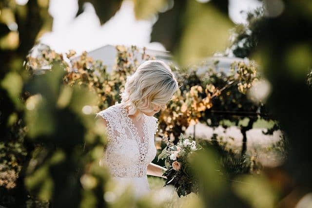 Bride walks the the vines