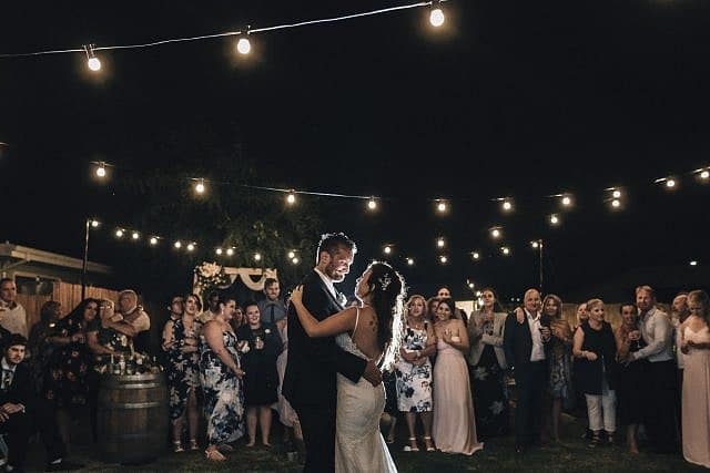 Recently hitched couple sharing their first dance in the DIY backyard property wedding