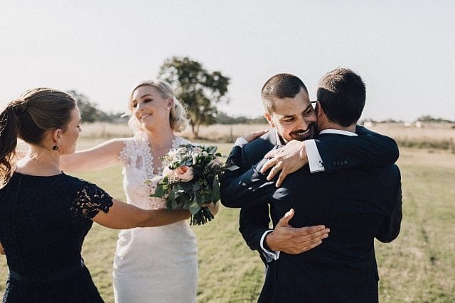 Bride & groom congratulated by bridal party