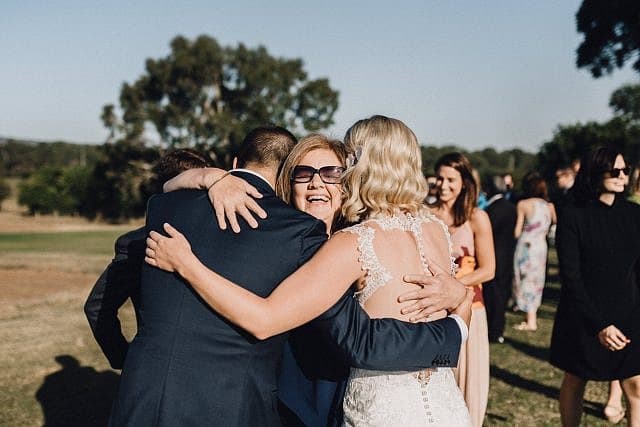 guests embrace Bride & Groom