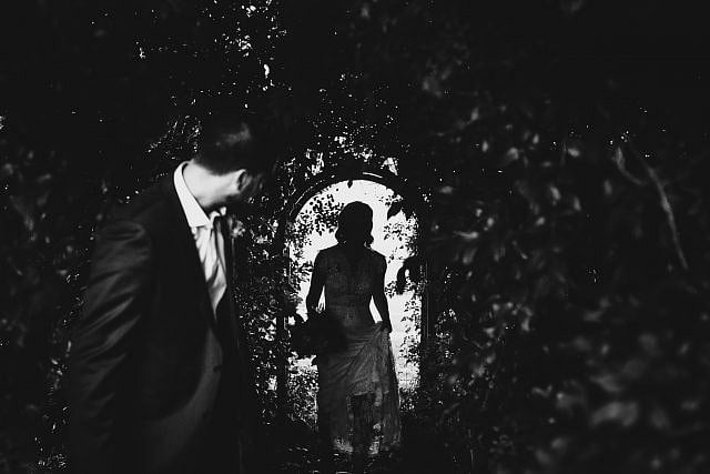 Groom waits for bride to emerge from shadows at Albion on the Swan