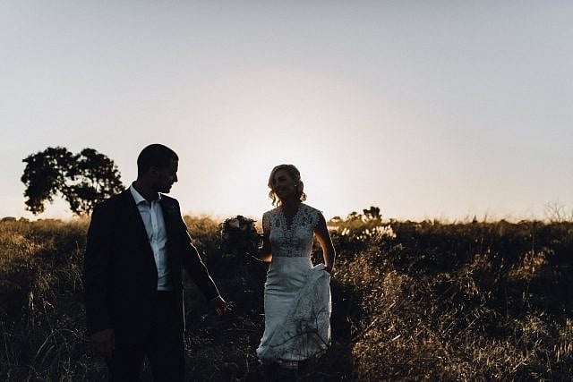 Groom waits for bride in the field at Beneath the Vines