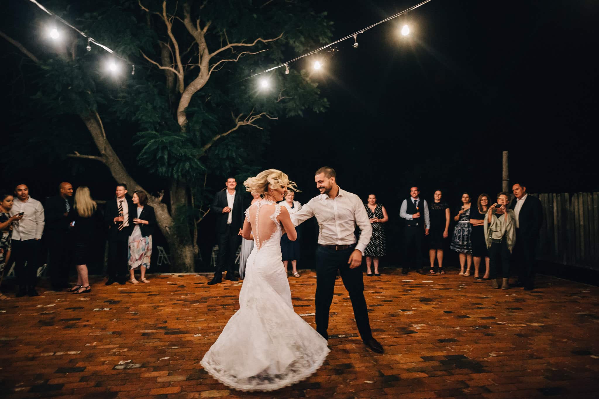 Bride Spins while dancing with Groom for their first dance at Albion on Swan outdoor under stars and lights