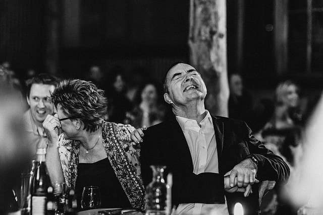 parents of brides laughing during speeches