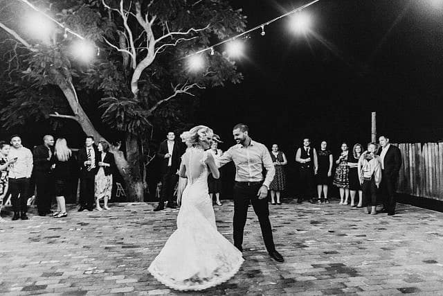 Bride Spins while dancing with Groom for their first dance at Albion on Swan outdoor under stars and lights