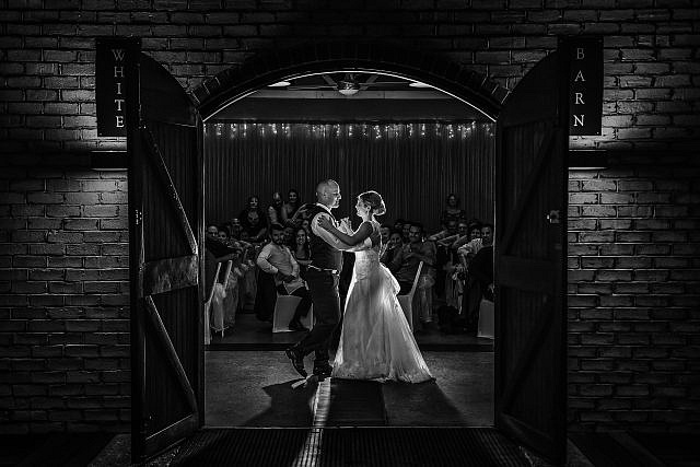 Married Wedding couple dance in the White Barn reception room at The Rose & Crown in Guildford
