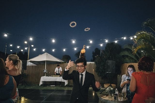 Guests play with games in the DIY backyard Perth property wedding