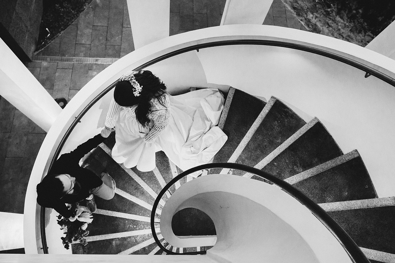 Bride & Groom Curing Down Stairs In City