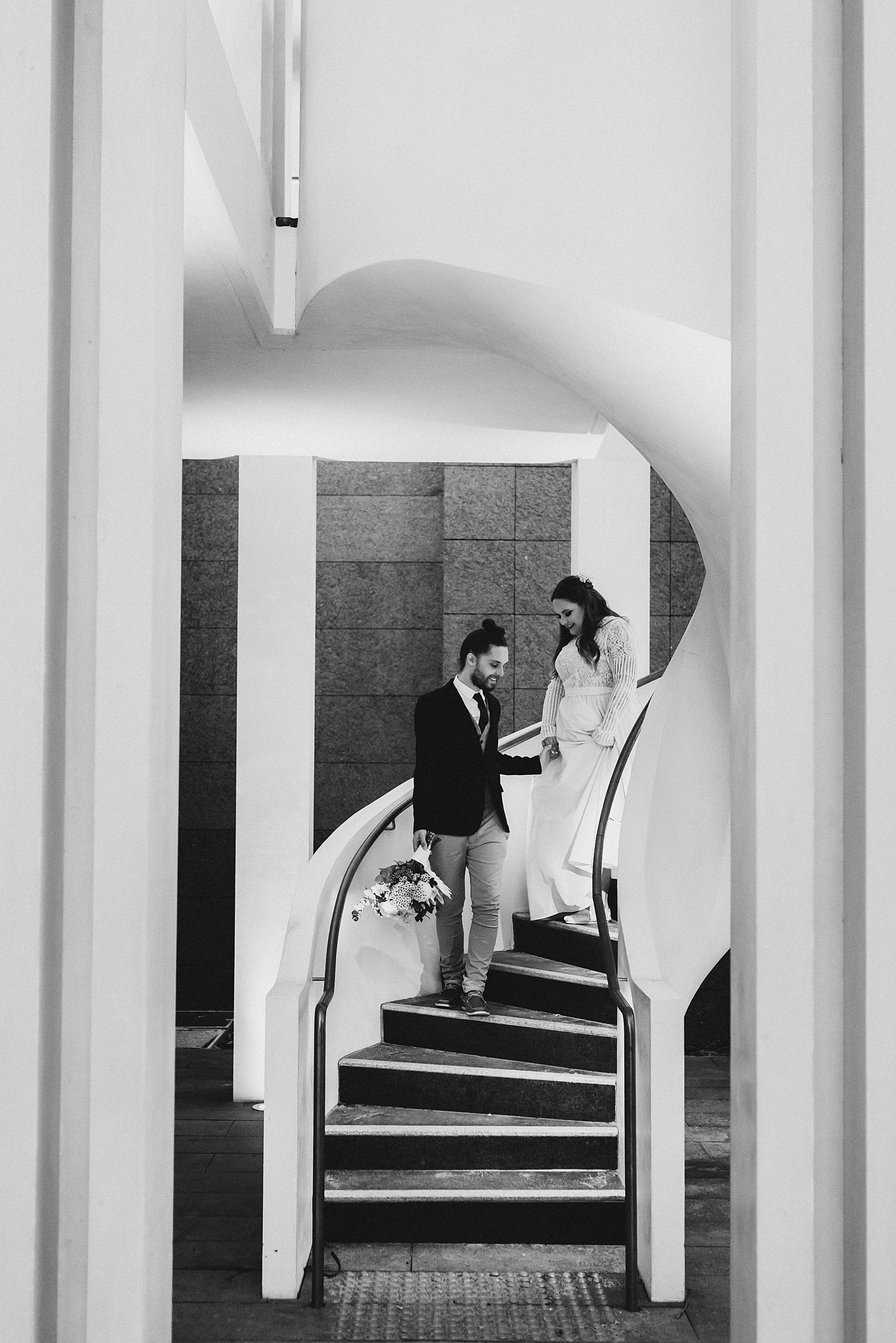 Grooms Helps Bride Down Stairs