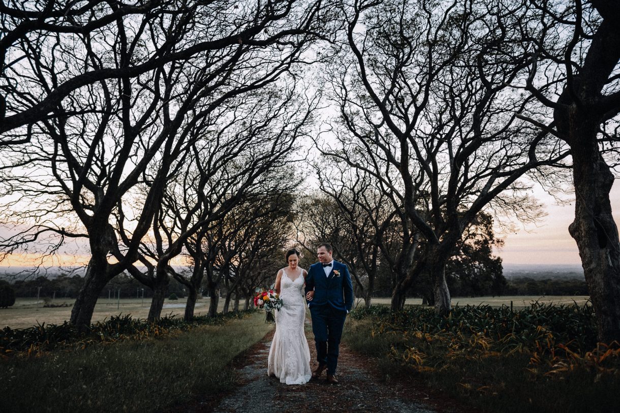 Bride & Groom walking through the trees at Quarry Farm Wedding