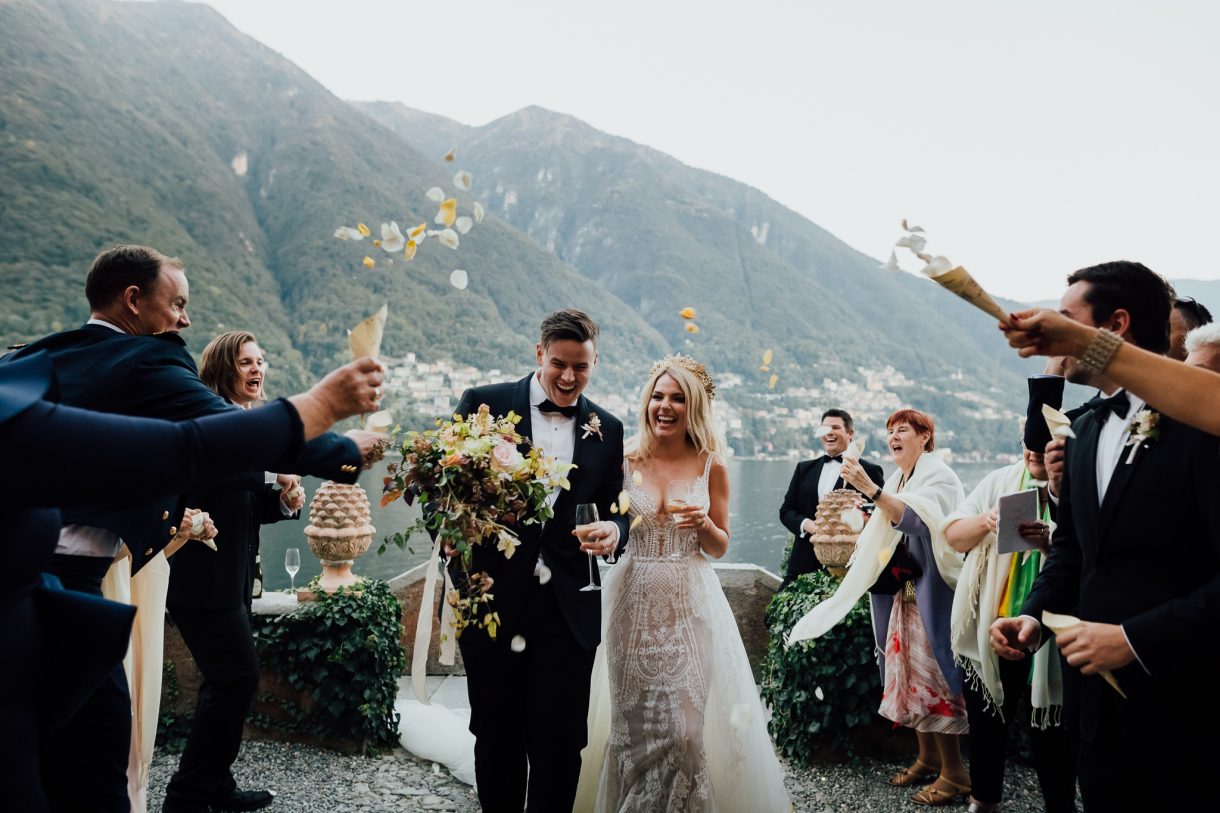Guests throw flowers at villa teodolinda lake como wedding